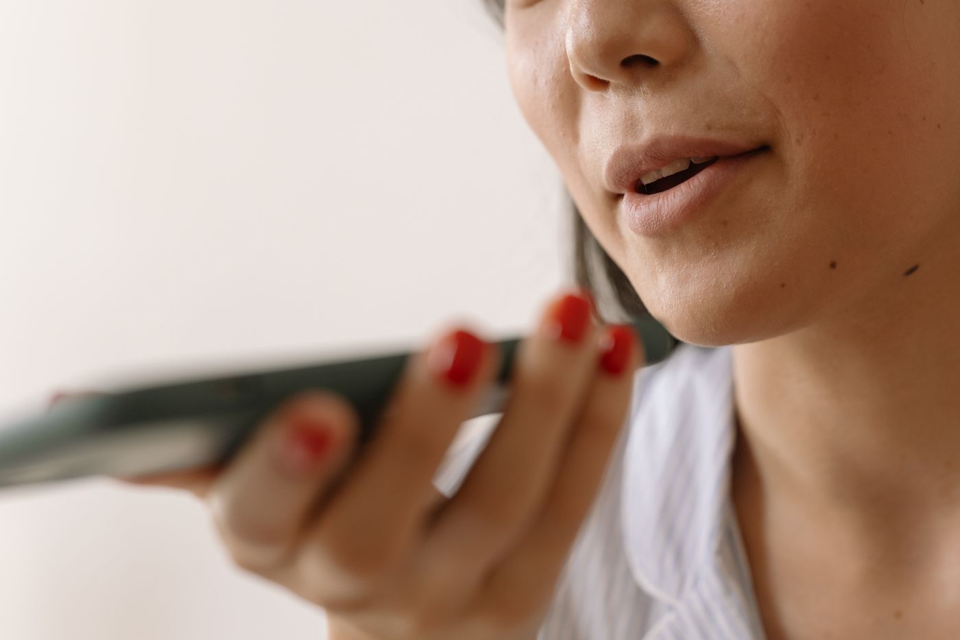 Person speaking into a smartphone while recording