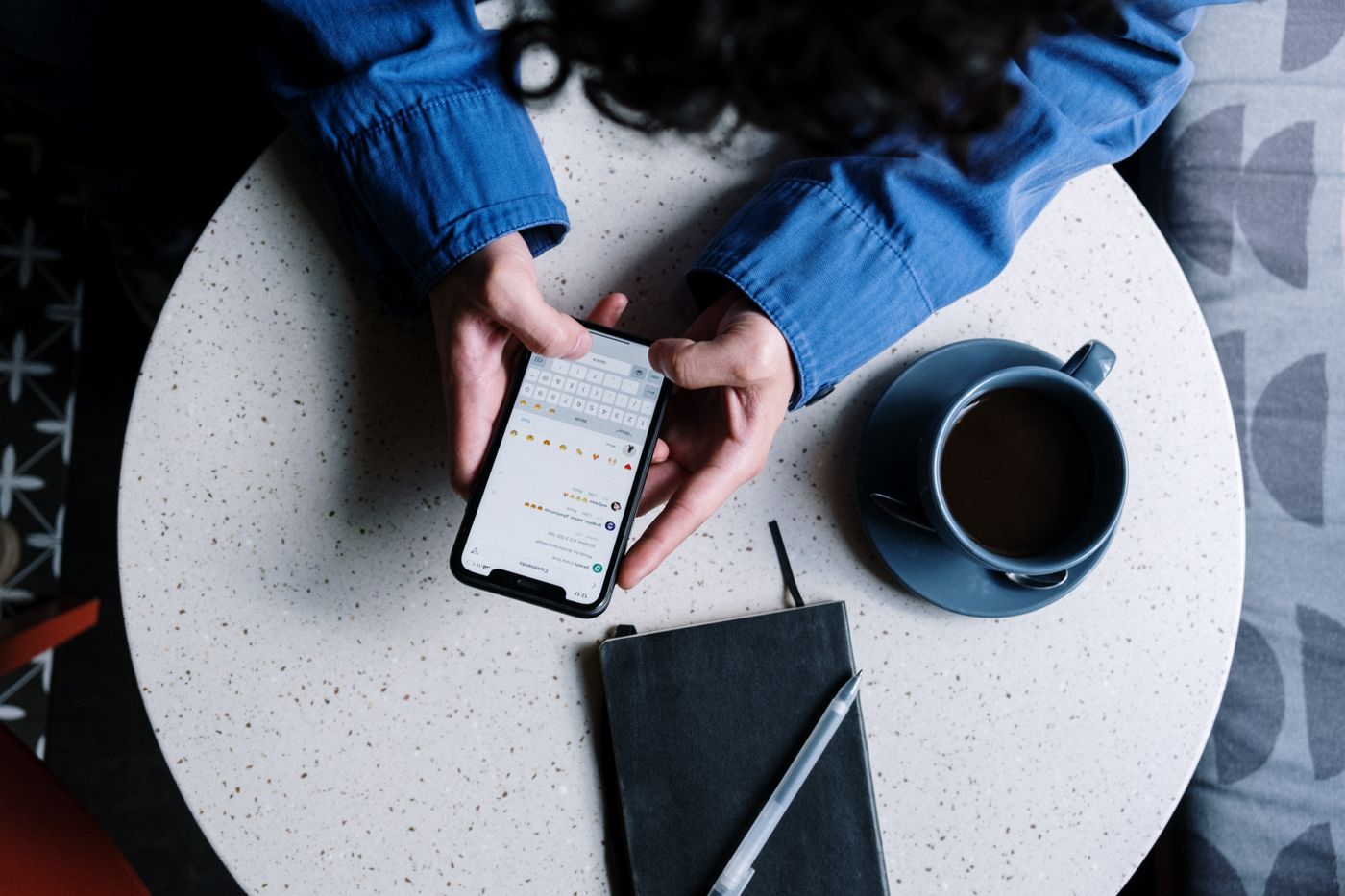 Person typing a written response on a smartphone